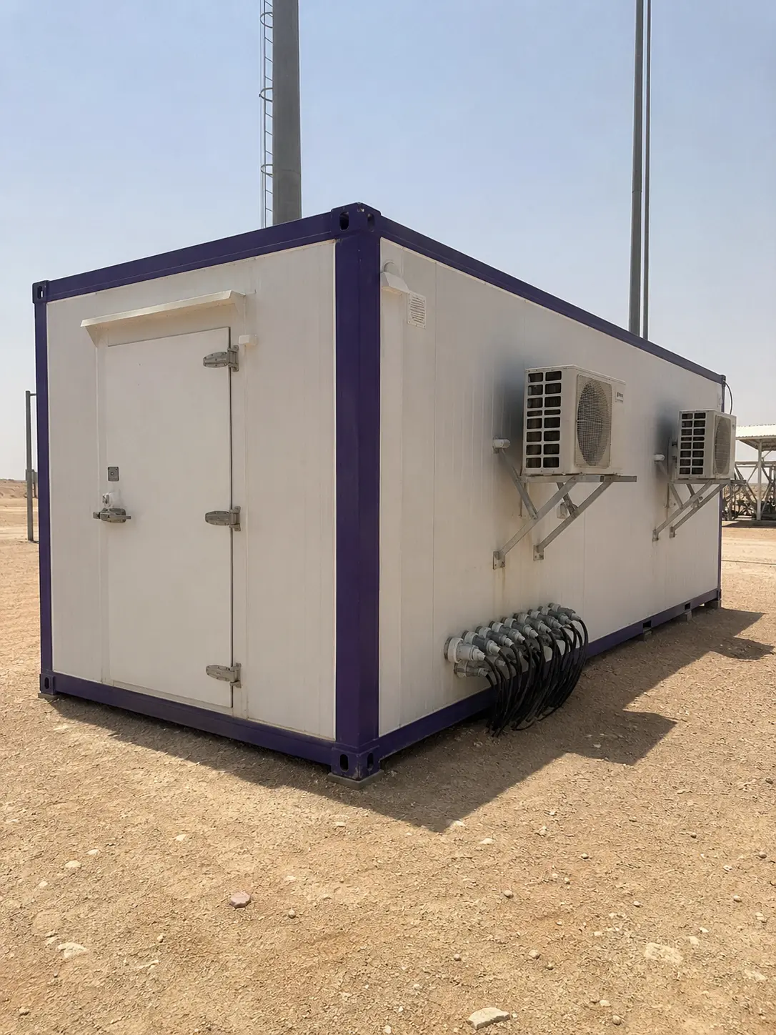 Authentic mobile photo of rugged Kenz telecom container shelter with heavy duty cooling in Saudi Arabian desert