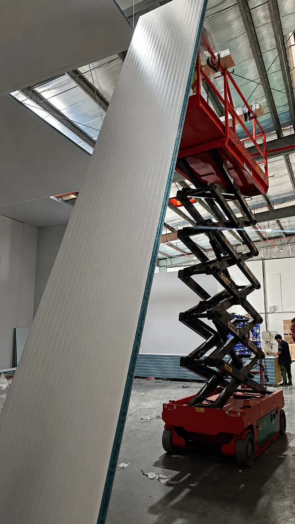 Cold Storage Assembly: Kenz technicians using scissor lift to assemble massive Polyurethane PU insulated panels
