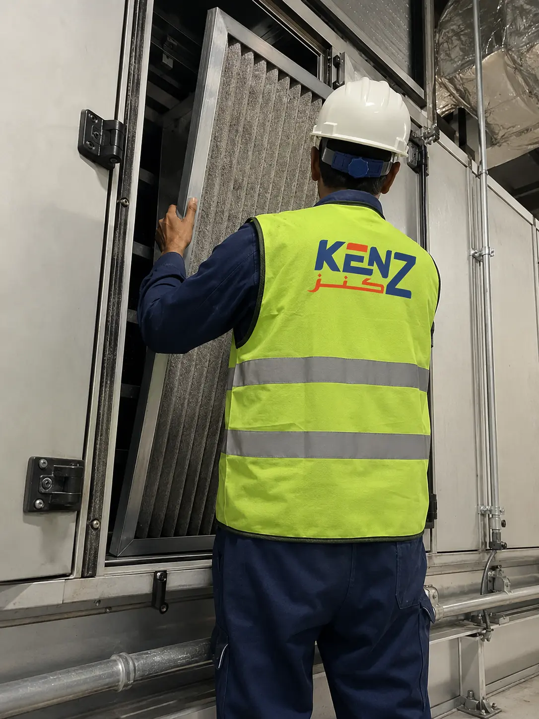 Kenz technician replacing thick industrial air filter in Air Handling Unit
