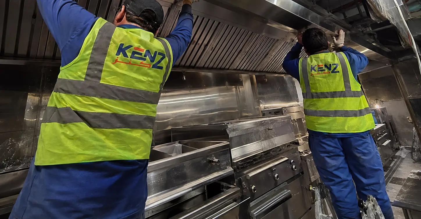 Kenz technicians installing massive stainless steel exhaust ventilation hood