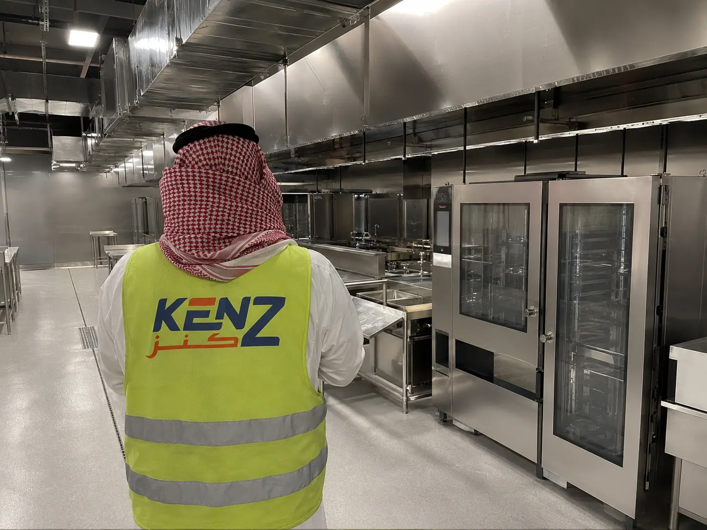Saudi Project Manager inspecting heavy-duty industrial ovens in Kenz commercial kitchen