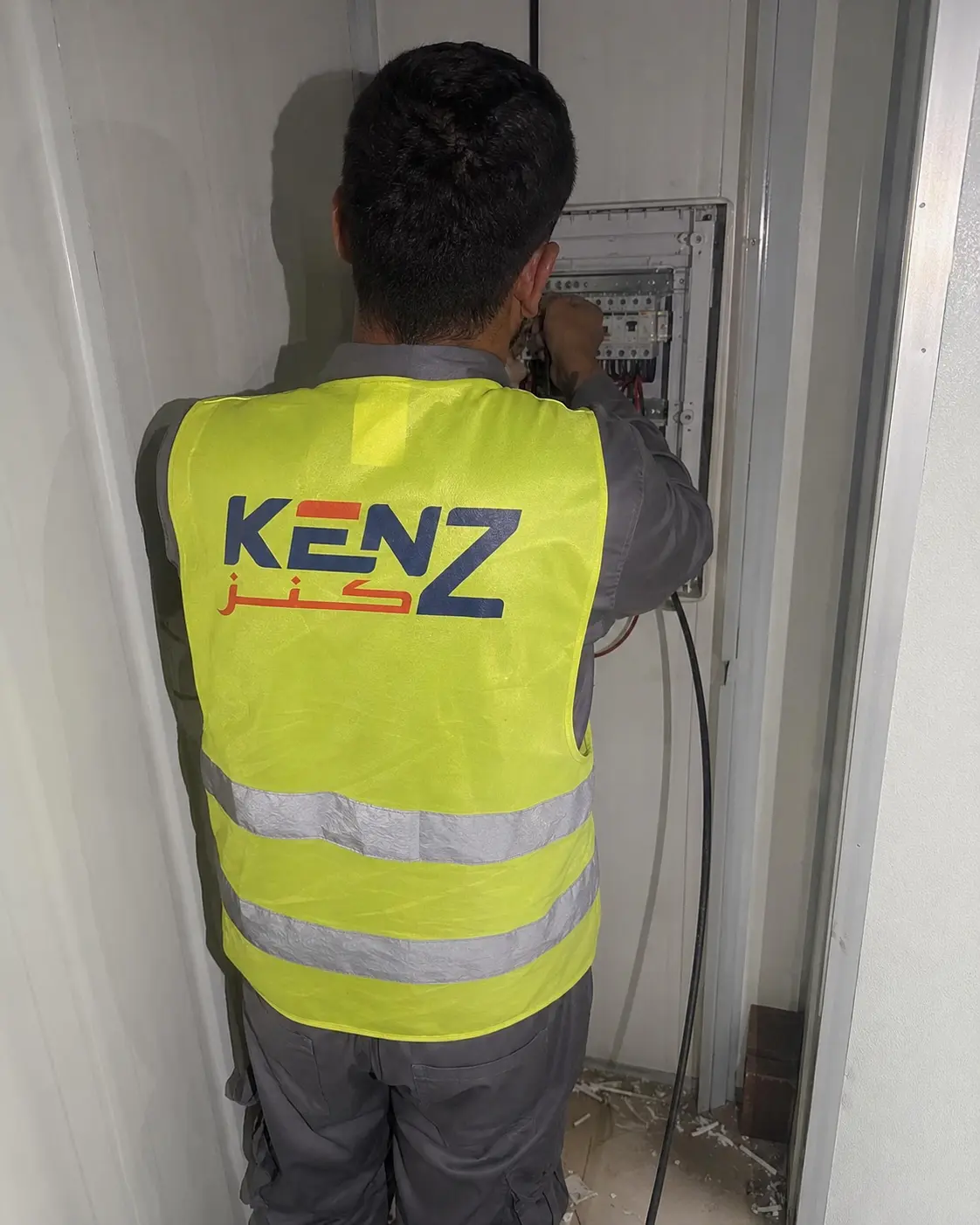 Workers installing insulated polyurethane sandwich panels for prefab building