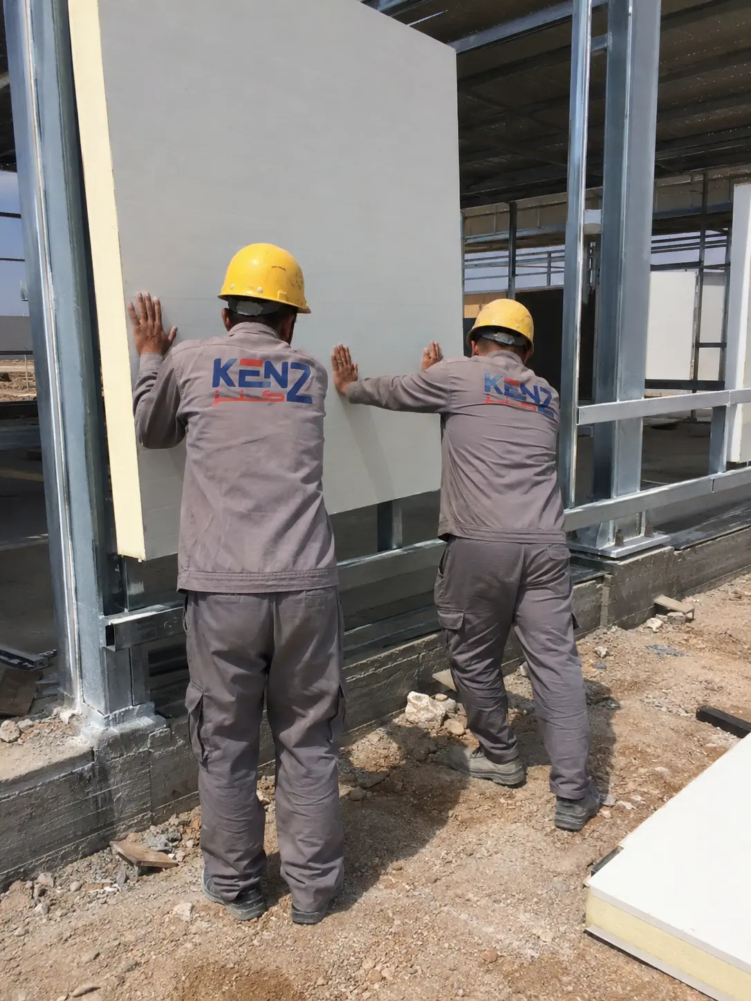 Technician installing electrical distribution board inside modular cabin