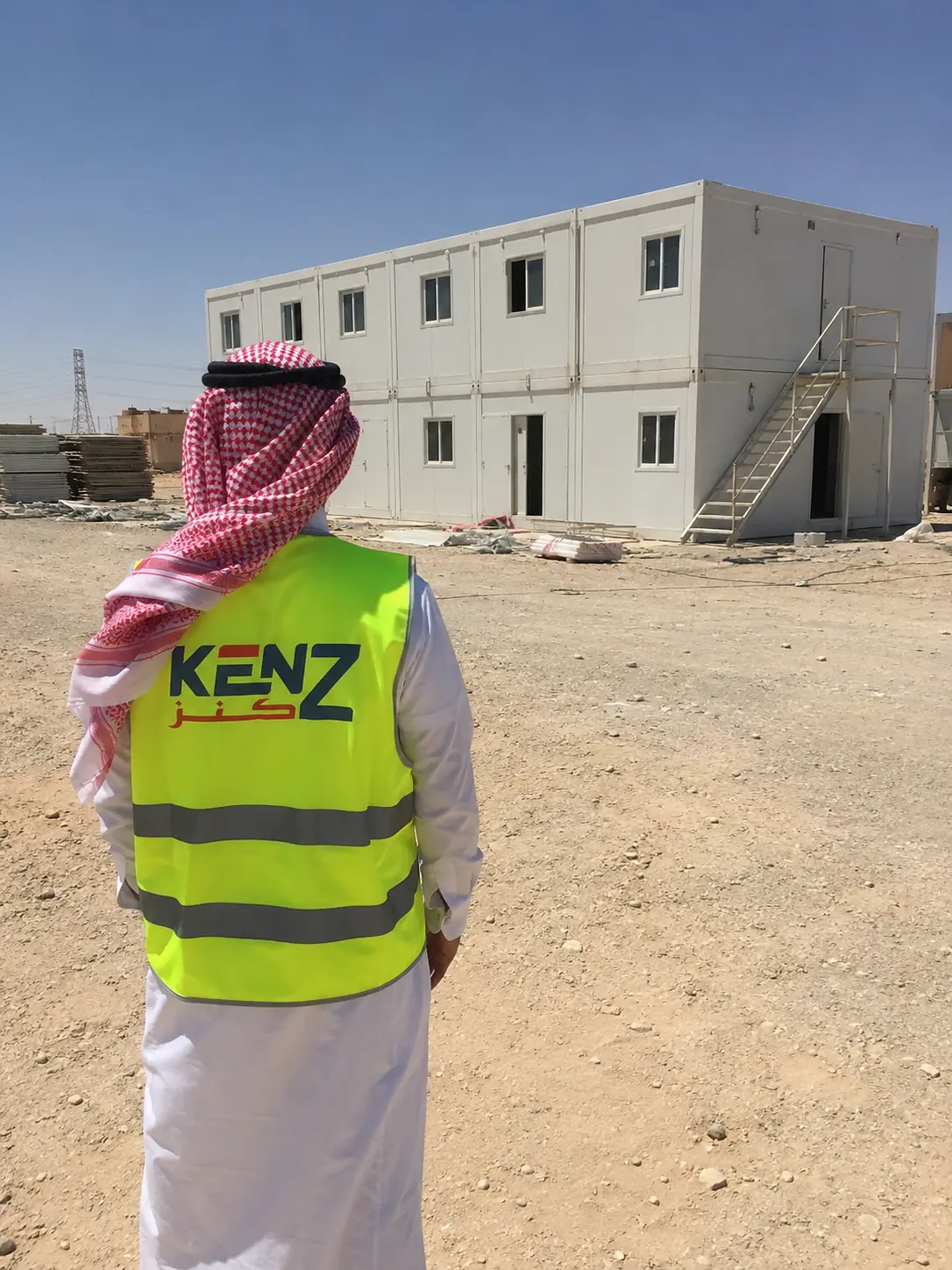 Saudi Project Manager inspecting two-story prefabricated modular labor camp in Riyadh