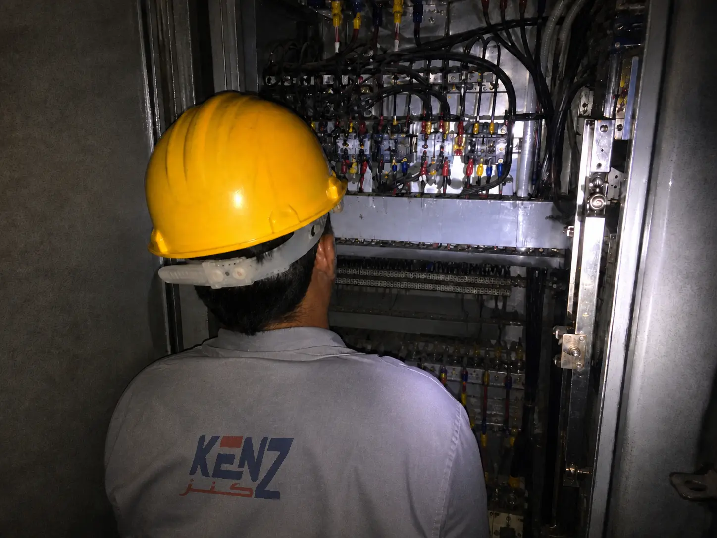 Kenz Electric Technician fabricating custom control panel in Saudi workshop