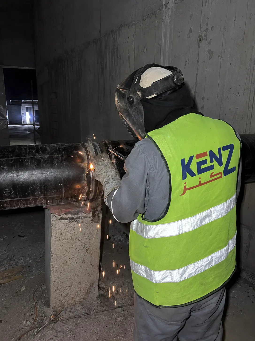 Kenz welder working on massive chilled water steel pipes