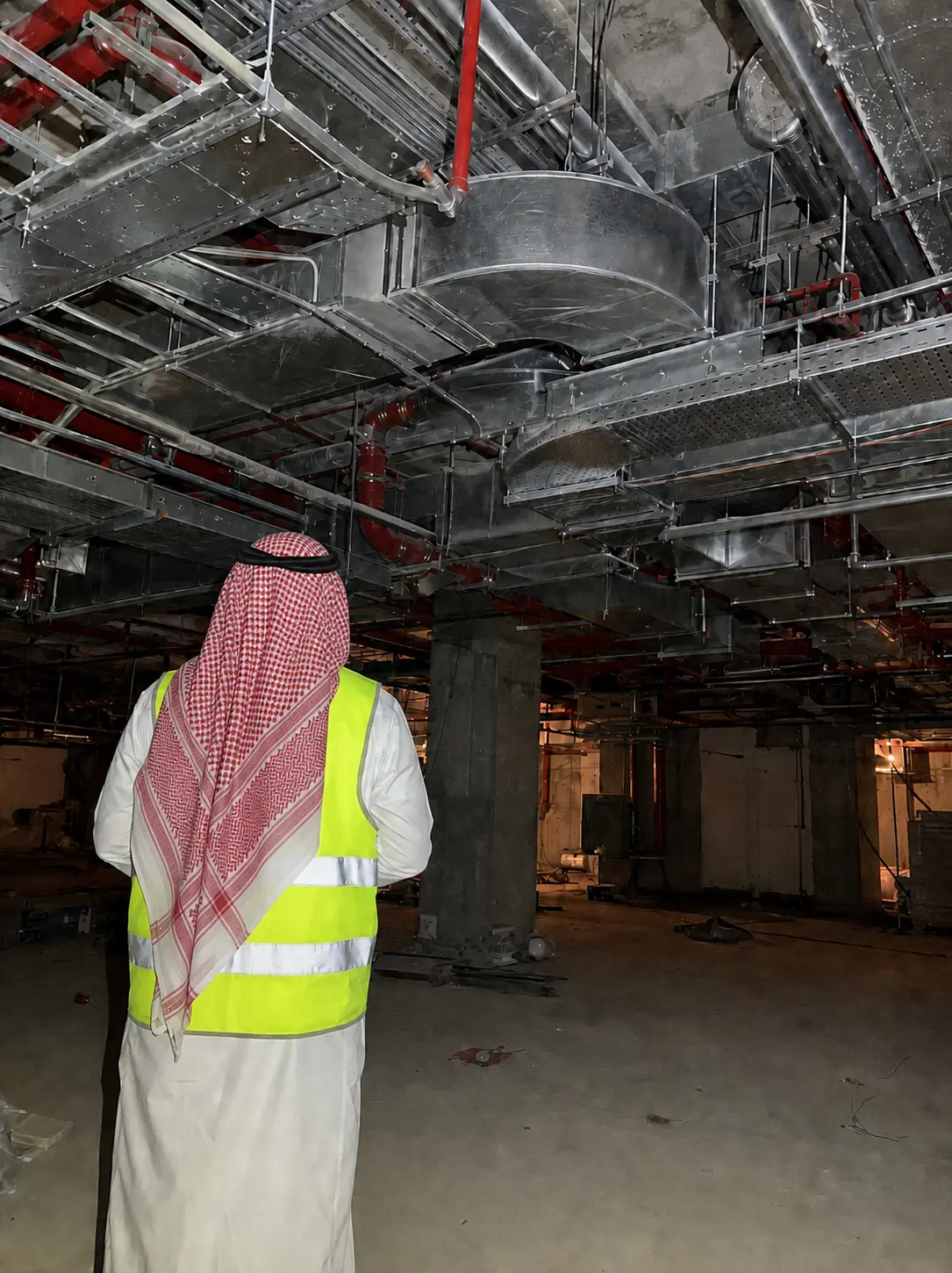 Saudi project manager looking at complex overhead MEPF ceiling coordination